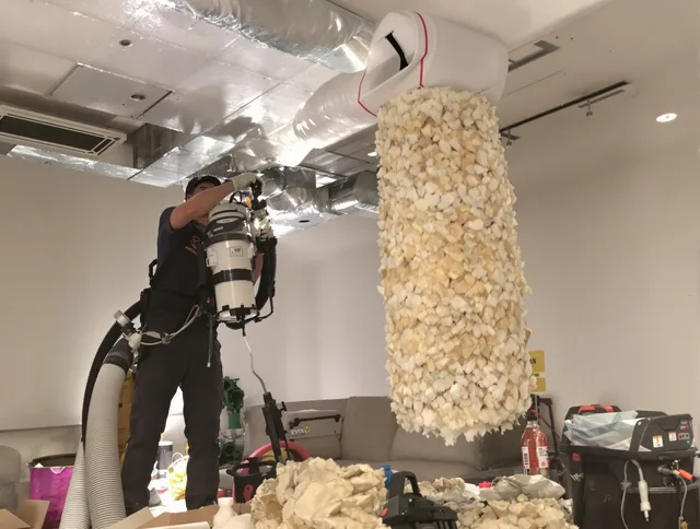 Marblehead Air Duct Cleaning technician performing precision vacuum insulation removal in a residential property in Marblehead